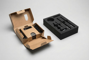 Side-by-side comparison of a sustainable folded paperboard insert and a traditional foam insert.